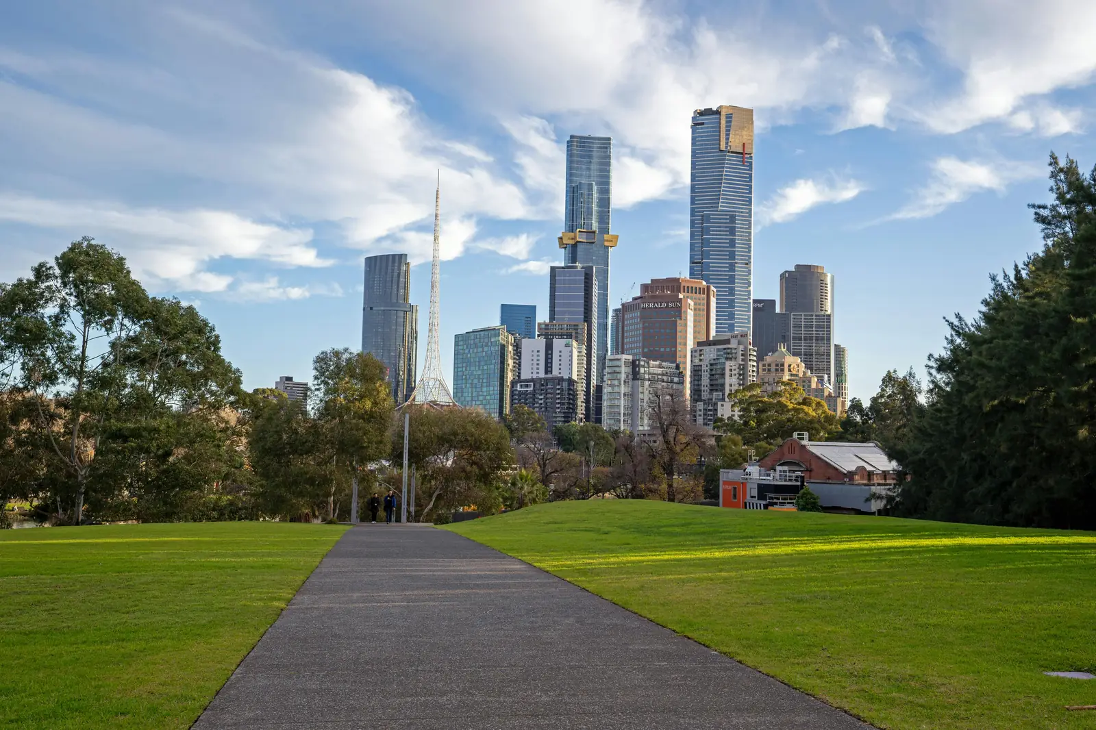 A riverside walking path in Melbourne with the city skyline