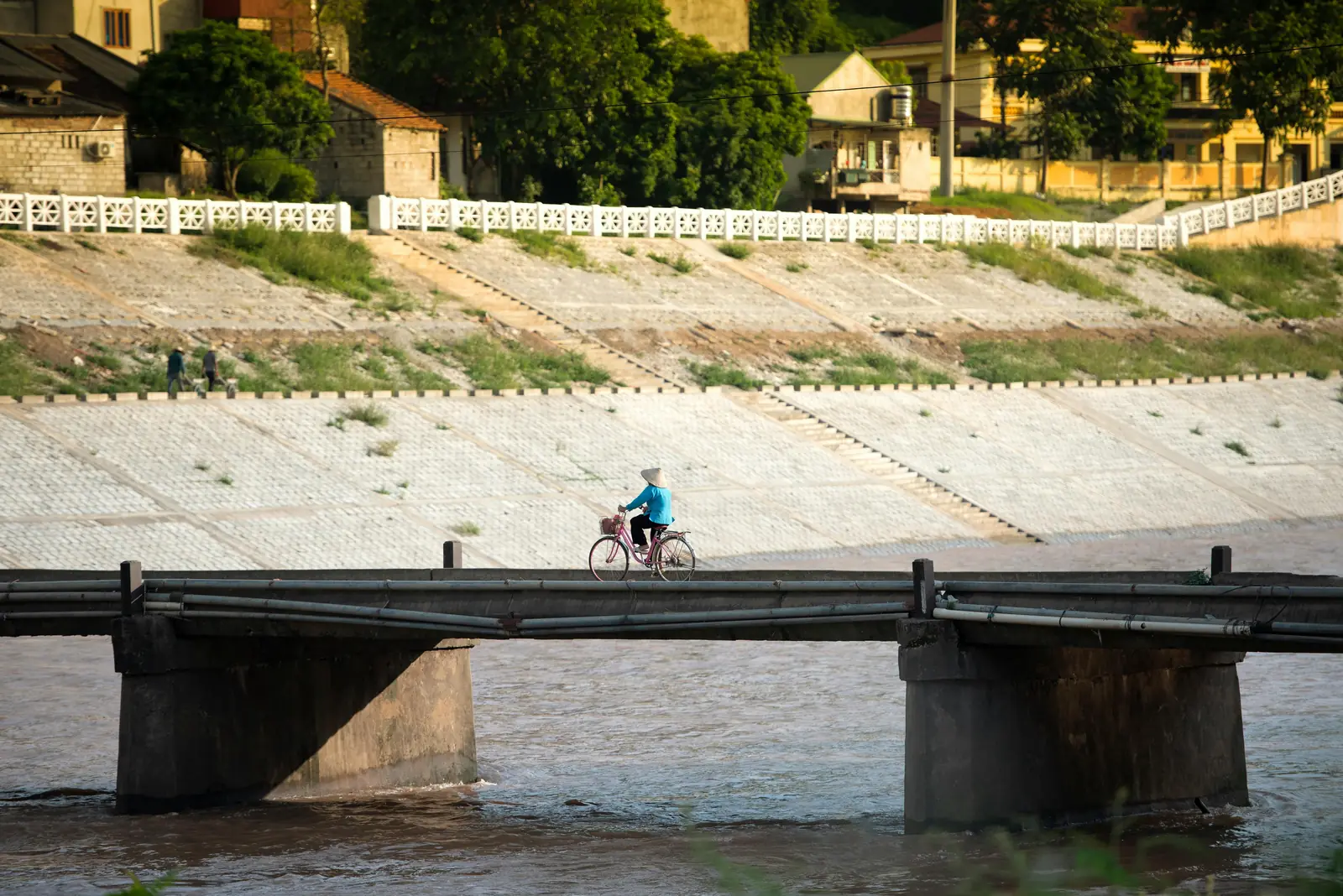 A cyclist riding along a riverside bike trail in Melbourne