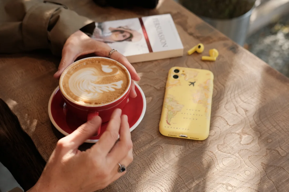 Close-up of a phone with maps and transport apps in a Melbourne cafe