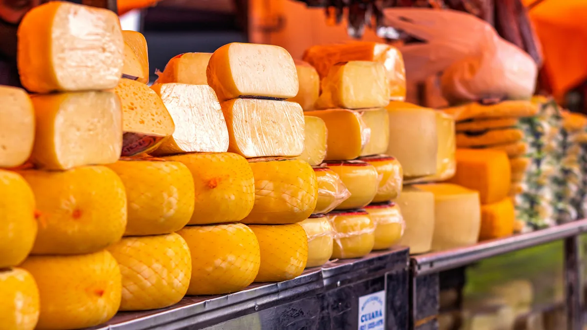A deli counter stacked with cheese and smallgoods at a Melbourne market