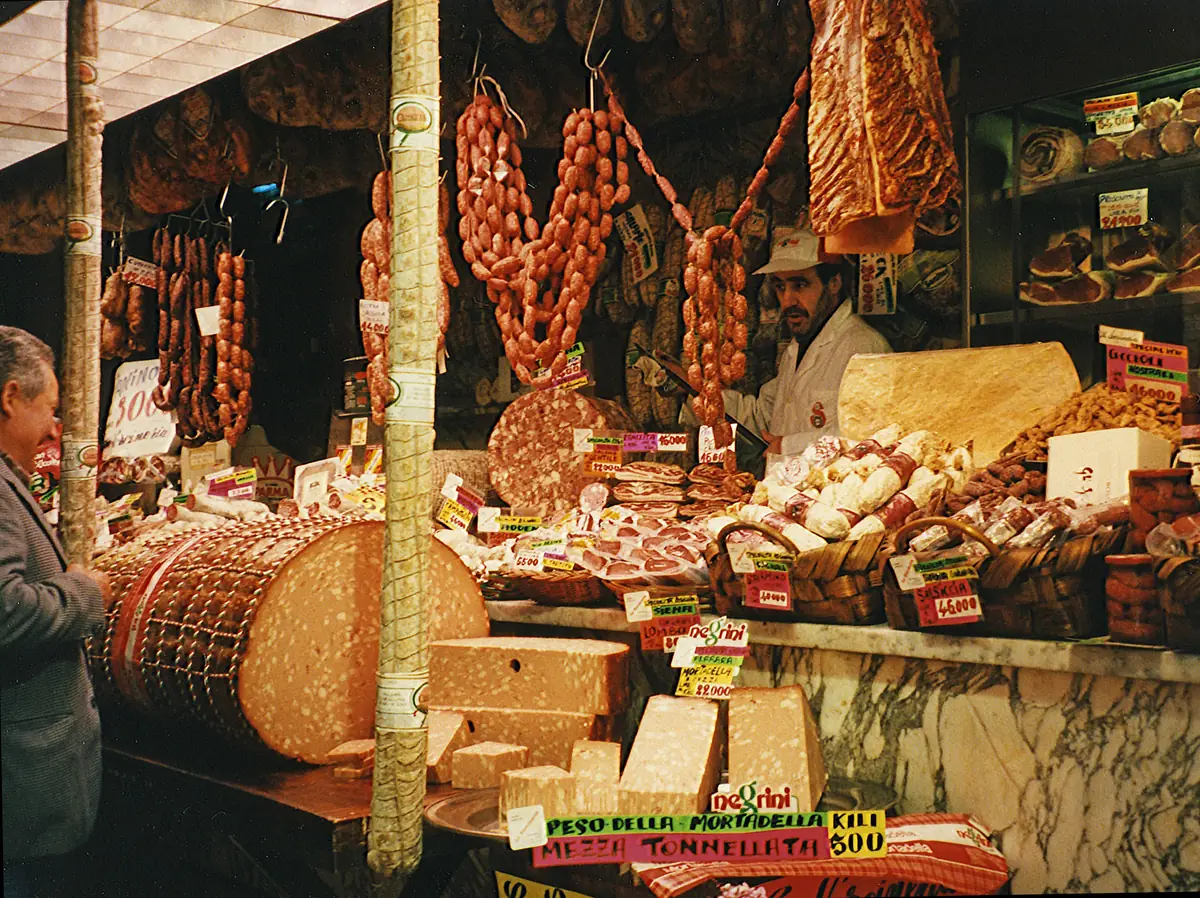 A guide showing visitors fresh produce and cheese at Queen Victoria Market