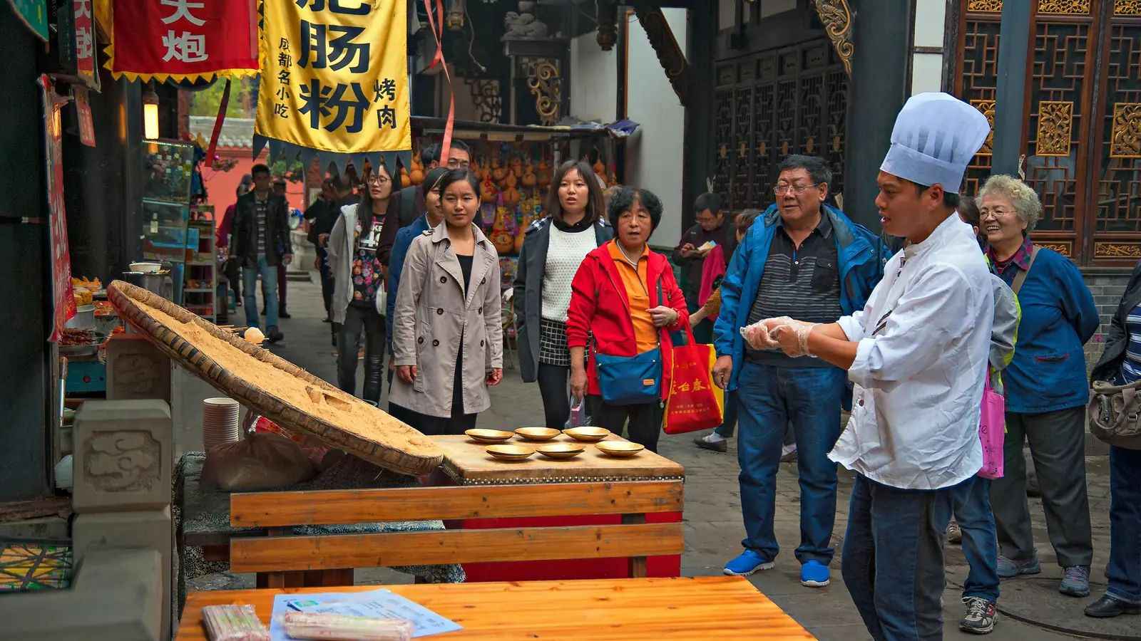 A small group on a food tour tasting dishes in a Melbourne laneway