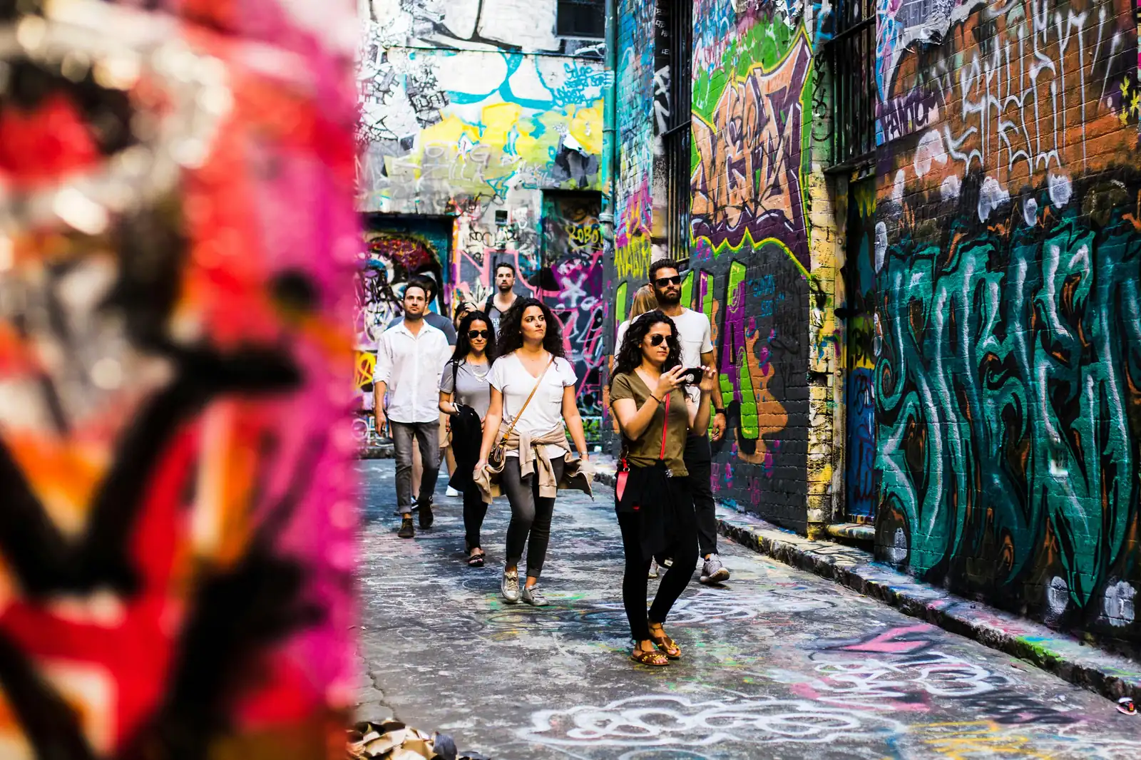 A free walking tour group exploring a Melbourne laneway