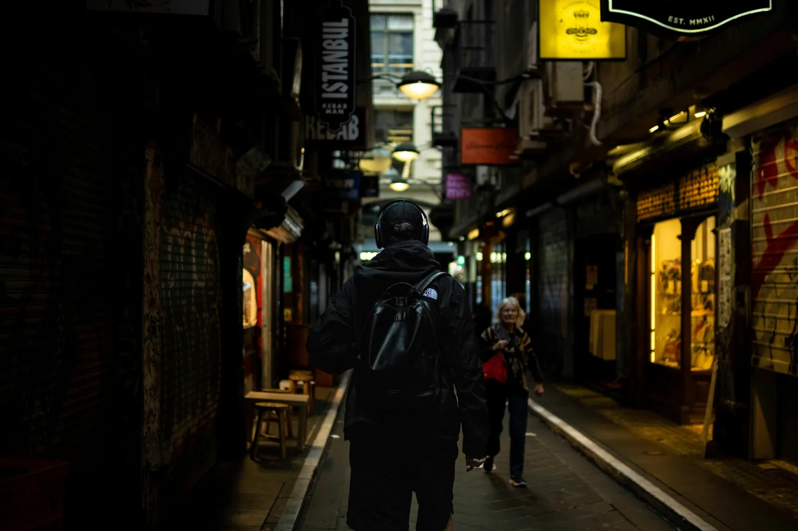 A hidden laneway bar entrance down a graffiti-covered alley in Melbourne