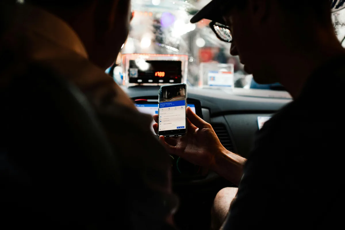 A phone showing a rideshare app map in Melbourne