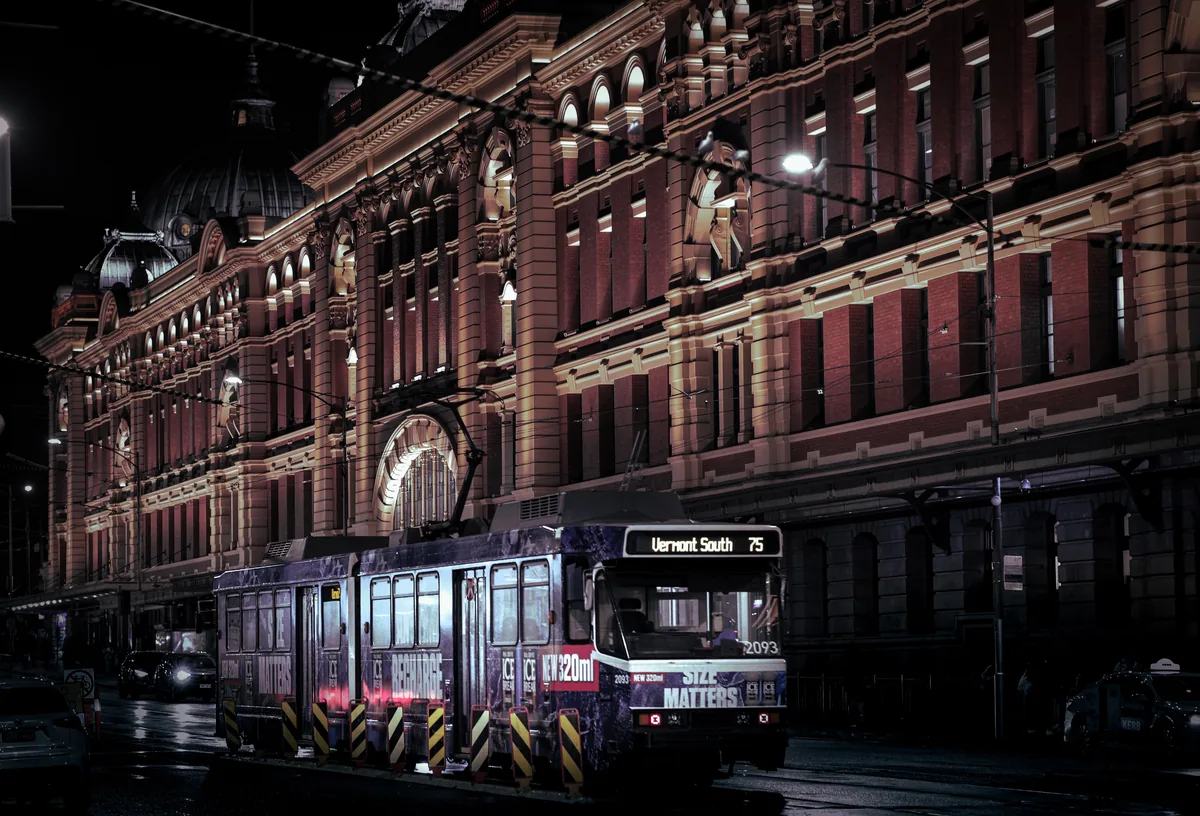 A Melbourne tram at night with passengers, showing safe public transport