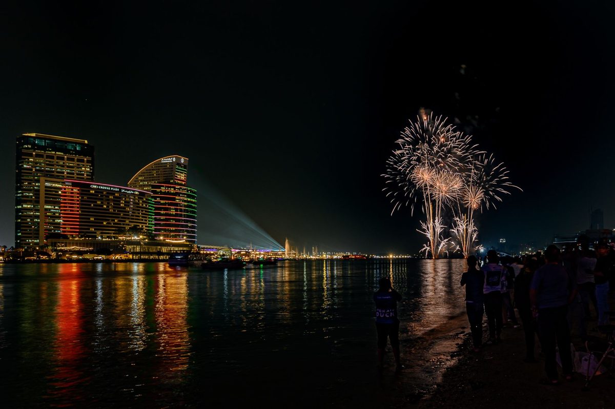 Fireworks over a city river