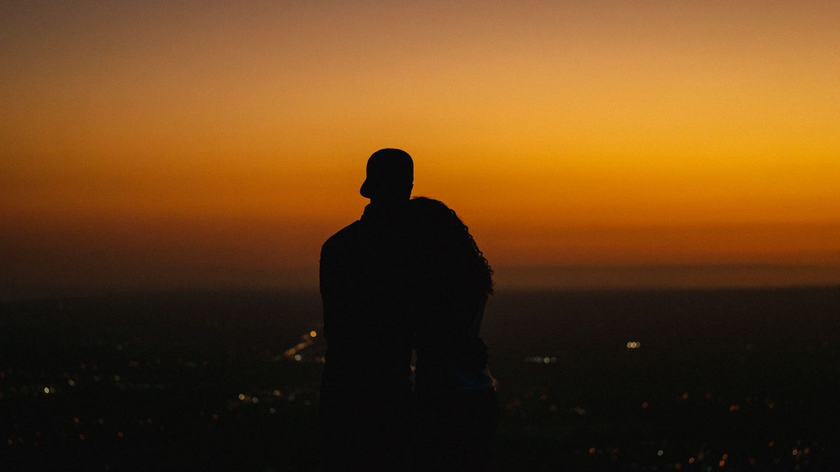 A couple watching a city sunset