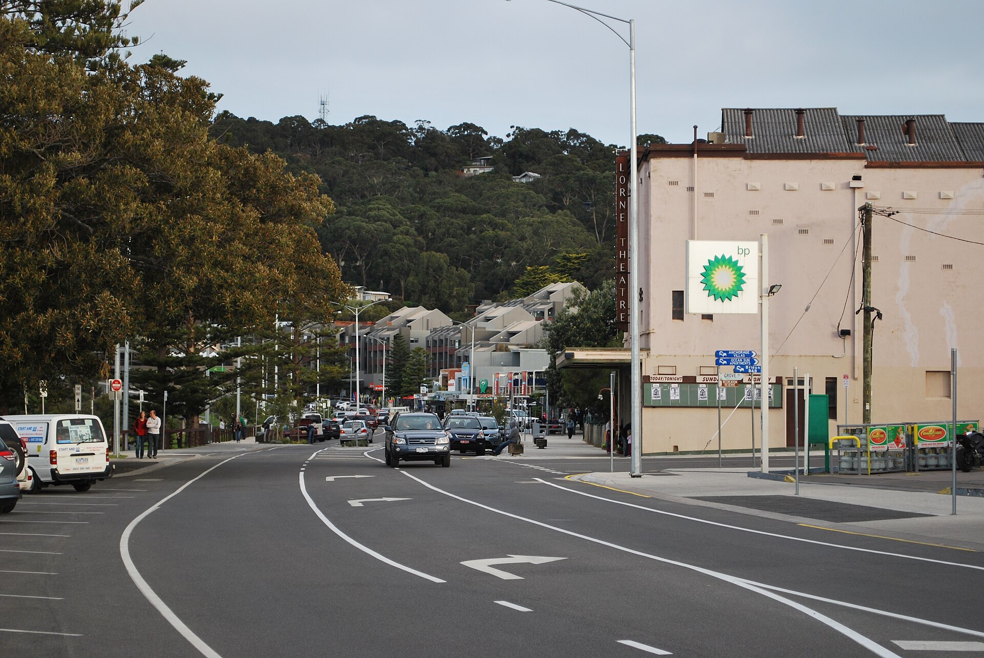 Mountjoy Parade in Lorne with the old Lorne Theatre building on the right, apartment buildings and forested hills behind