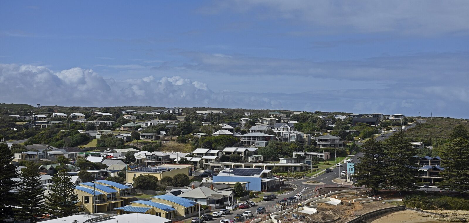 Port Campbell town seen from above, with motels and houses rising behind the sheltered beach
