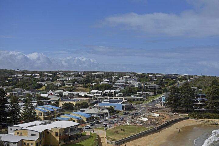 Port Campbell town seen from above, with motels and houses rising behind the sheltered beach