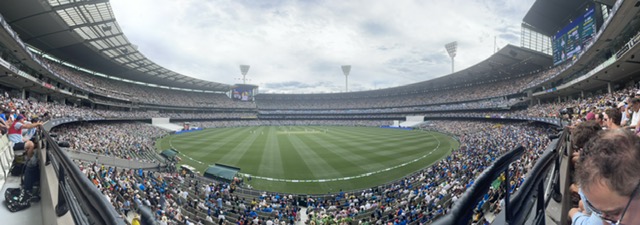 A wide view across the MCG during the 2024 Boxing Day Test, with packed stands curving around the oval and the floodlight towers above