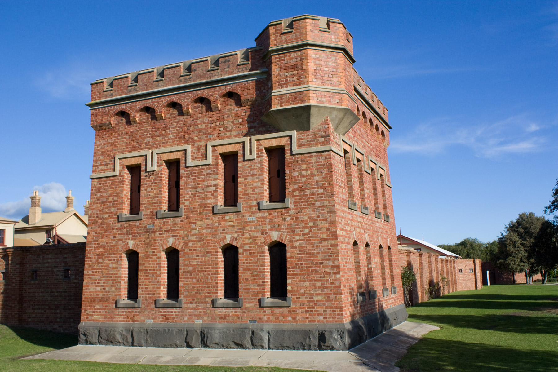 The square red-brick keep of Fort Queenscliff with crenellated parapets under a blue sky